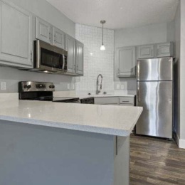 kitchen with ample counter-space, modern appliances and bright lighting