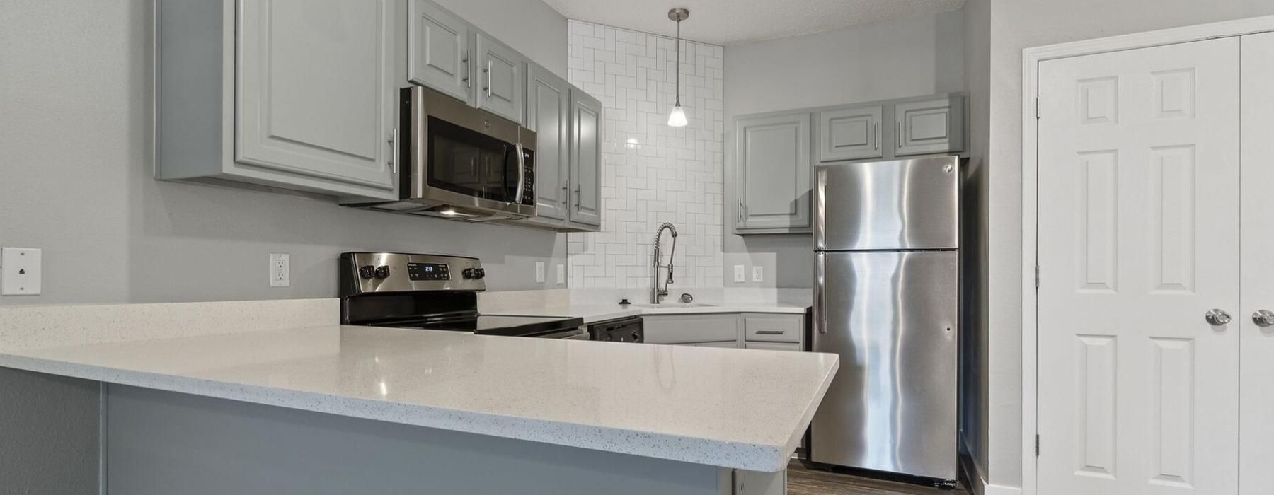 a kitchen with white cabinets